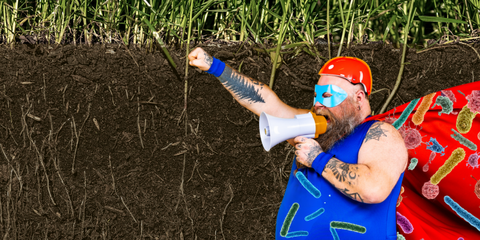 man dressed in superman costume covered in microbe illustrations